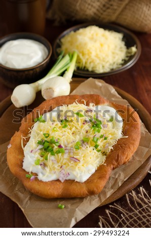 Langosz / langosh - hungarian fried potato and yeast pancakes with sour cream, cheese and green onions