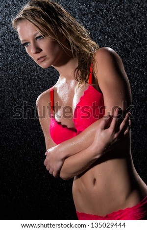 Looking away seductive wet woman in red bra and underwear