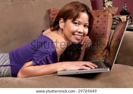Young woman relaxing in the sofa and navigating in internet.