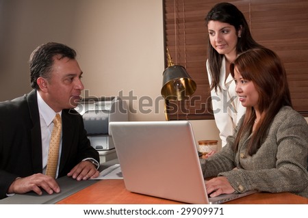 Small business owners meeting in an office for an interview.