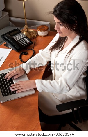 Young businesswoman working in the office in her computer.