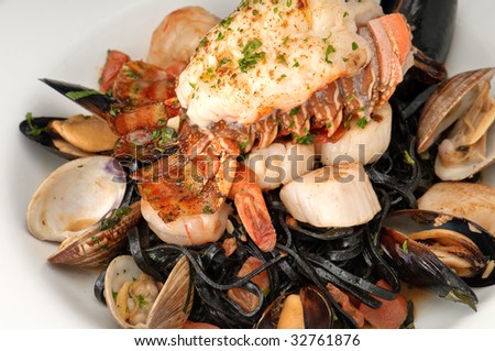 Plate of lobster served with sauteed jumbo shrimp, oysters and linguini pasta.