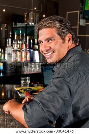 Young man relaxes and working in a bar.