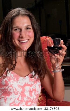 Young woman very happy drinking wine in a restaurant.