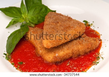 Plate of fried mozzarella with marinara sauce and parsley.