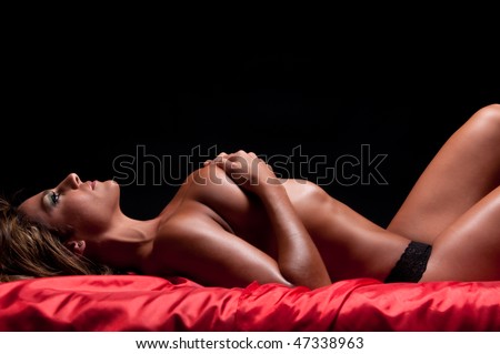 stock photo Sensual woman laying in bed naked