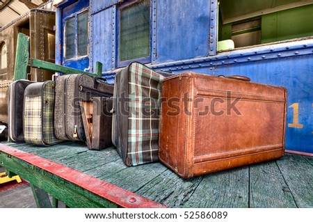 Old luggage over a cart in an old train station over a cart in an old train station over a cart in an old train station