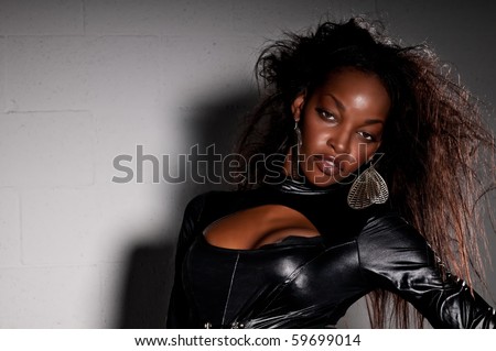 stock photo Sensual African American with leather catsuit posing