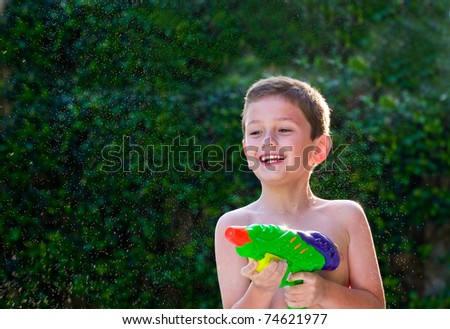 Kid playing with water toy in the summer.