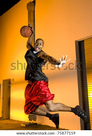 Basketball player jumps with ball