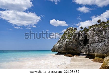 A gorgeous beach in Tulum, Mexico. Turquoise water and deep blue sky.