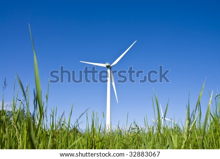 Wind turbines in a field. Modern day windmills producing green energy.