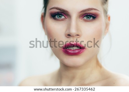 The girl with the smeared lipstick. Studio portrait.