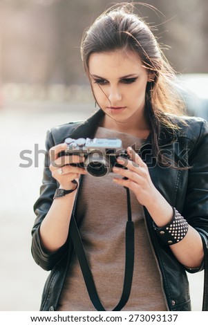 the woman watches the pictures photographed on a camera