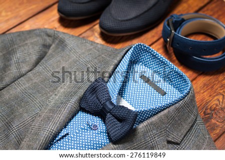 Men\'s suit, belt and footwear on a wooden background