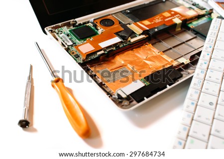 Closeup photo of the disassembled broken computer (laptop). Repair set