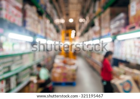 Blurred image of Wholesale Supermarket with worker