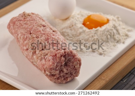 ground meat on plate with eggs
