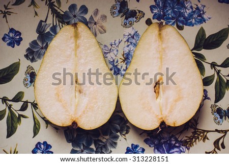 Sliced pears on floral patterned table cloth