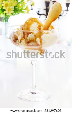 natural italian ice cream in a glass cup with caramel