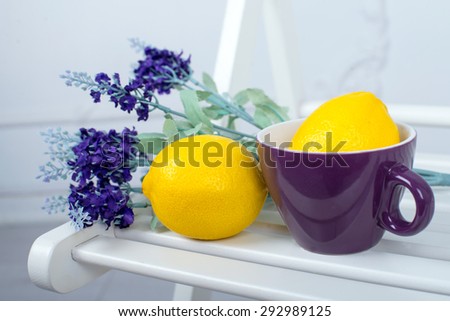 Still life with fresh lemons and lavender on a white chair
