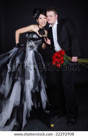 Young couple smiling with red roses