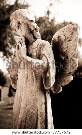 Woman angel with her hands folded in prayer.
