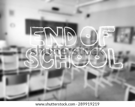 A chalk lettering with a blurred classroom in the background - black and white photography.