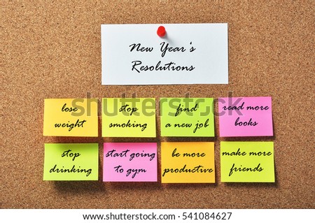 New Year\'s Resolutions on notice papers hanging on a cork bulletin board