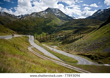 curved road on alpine pass in switzerland alps