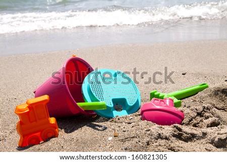 plastic toys on the beach  near the ocean