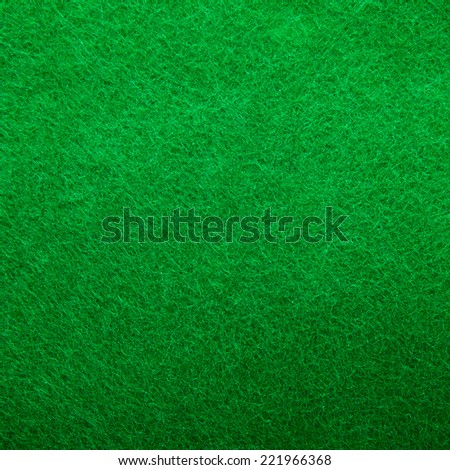 Background texture of green felt casino table in closeup