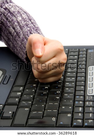 Angry fist on computer keyboard over white background