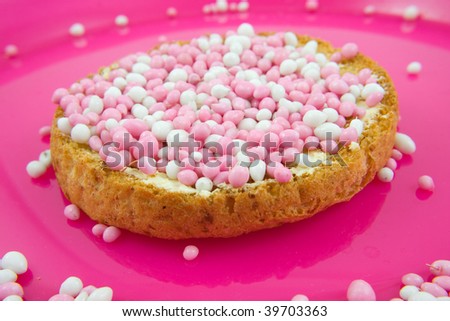Rusk with pink and white mice, it\'s a girl! On pink plate in closeup