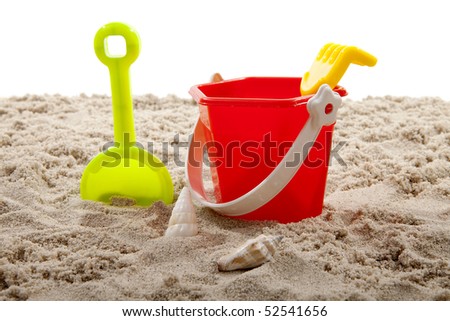colorful plastic toys for the beach on sand over white background