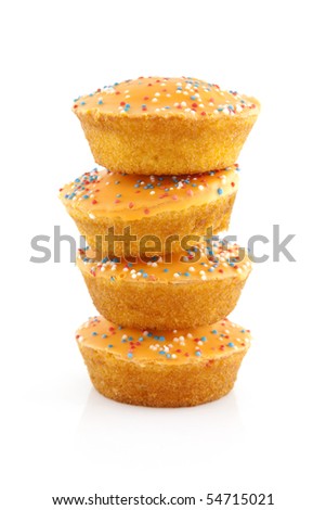 Pile big orange cake cookies for Dutch soccer with confetti over white background