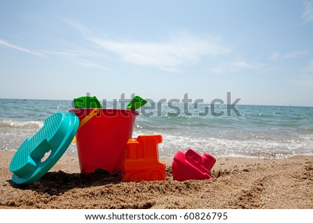 plastic colorful toys at the beach near the ocean