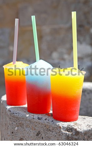 colorful slushy ice drinks in plastic cups