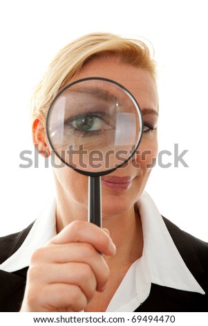 Big brother is watching you: business woman with magnifying glass to the eye over white background