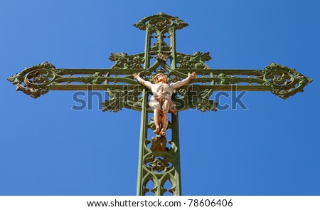 Statue of jesus on cross against blue sky