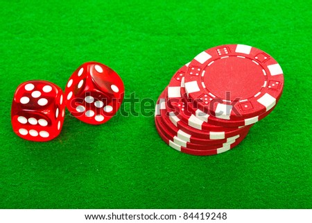 casino chips and red dices over green background