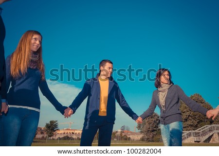 Multiracial Young People Holding Hands in a Circle