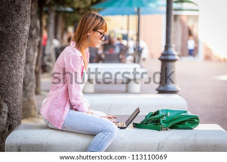 Beautiful Young Woman with Computer Outside