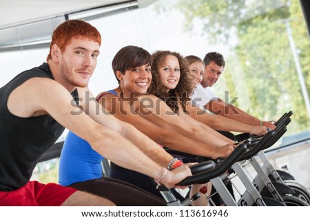 Group of People Cycling at Gym