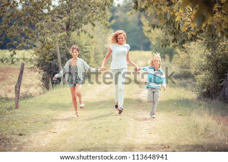 Beautiful Young Woman with Two Children Outside