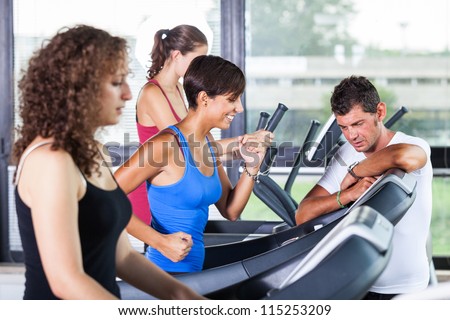 People Running on Treadmill in the Gym