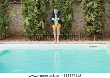 Young Businessman with Swimming Trunks next to the Pool