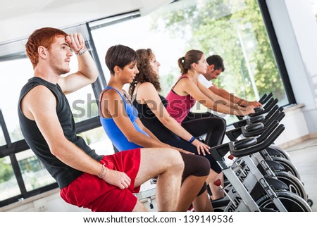 Group of People Cycling at Gym