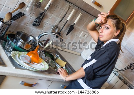 Housemaid Washing Dishes in the Kitchen