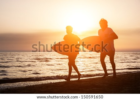 Two Boys with Surf Boards at Sunset Two Boys with Surf Boards at Sunset